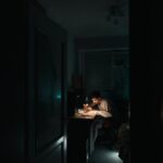 student doing homework at table at night