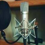 a close up shot of a microphone and a pop filter
